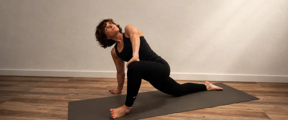 Estocada baja con torsión durante una clase de yoga terapéutico
